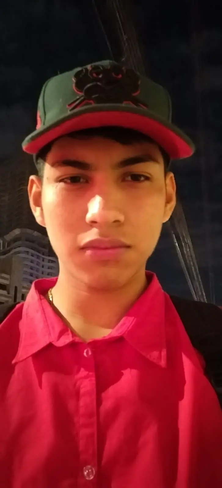 Gemini, Personal Al Assistant: Prompt; Use the photo above as the reference. Create a photorealistic Hong Kong retro portrait with authentic 1990s film look, like a moody movie still. Strictly preserve identity (eyes shape, lips, nose bridge, jawline, skin tone). Vertical portrait, mid-thigh to head (3/4 body). Subject standing, leaning slightly toward camera with both hands resting on a small wooden cabinet behind her; shoulders relaxed. Chin slightly down, gaze up toward camera with a melancholic, calm expression. Scene: tight messy Hong Kong room, walls plastered edge-to-edge with yellowed Cantonese newspapers. Behind subject: hazy neon Chinese signage (red + cyan) glowing through mist near the ceiling.
Cluttered furniture: compact cabinet, scattered cables, small mirror edge visible. Wardrobe & Styling: cream/ ivory lace corset-style dress (tasteful, non-revealing), layered delicate gold necklaces, small hoop or pearl earrings. Hair tousled with wispy bangs across forehead.
The face must be a precise copy of my real facial features, do not change the face, and make it a high-resolution photo.